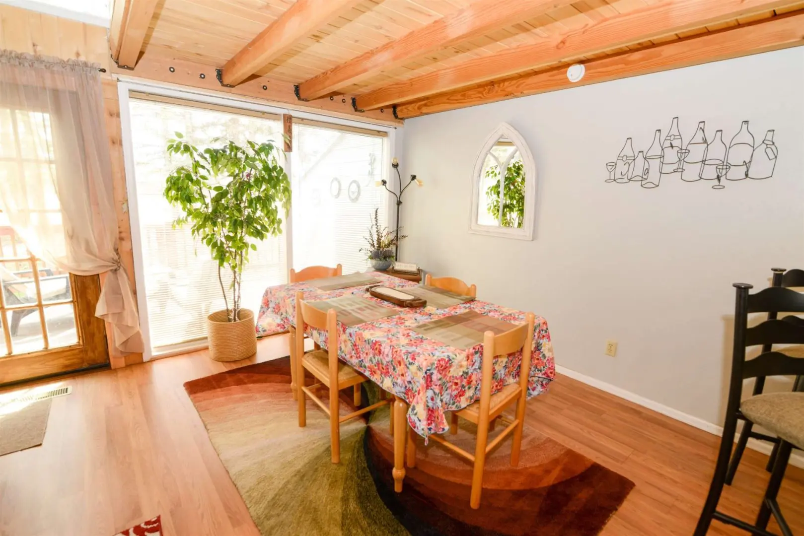 A dining room with a wooden table and chairs.