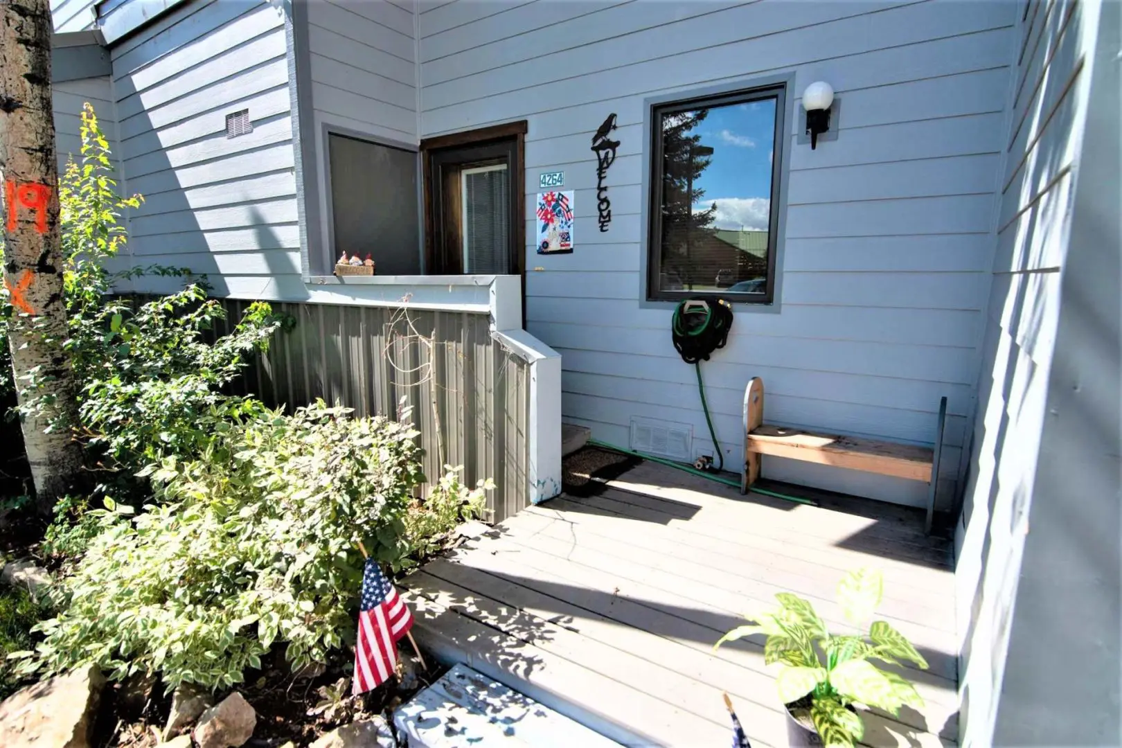 A front porch with an american flag on it.