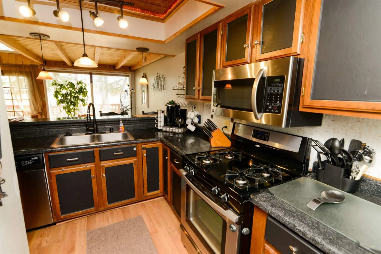 A kitchen with stainless steel appliances and wood cabinets.