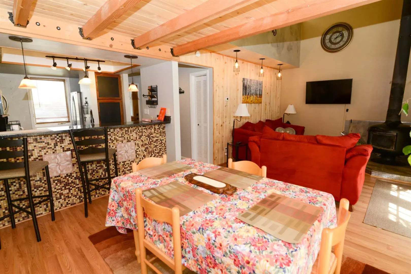 A living room and dining room in a log cabin.