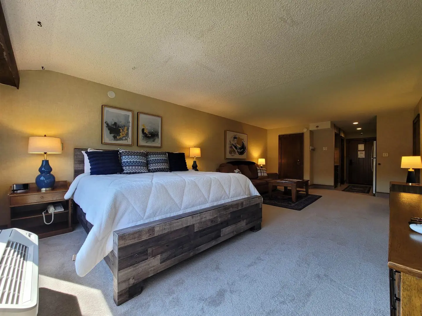 A bedroom with a large bed and a flat screen tv.