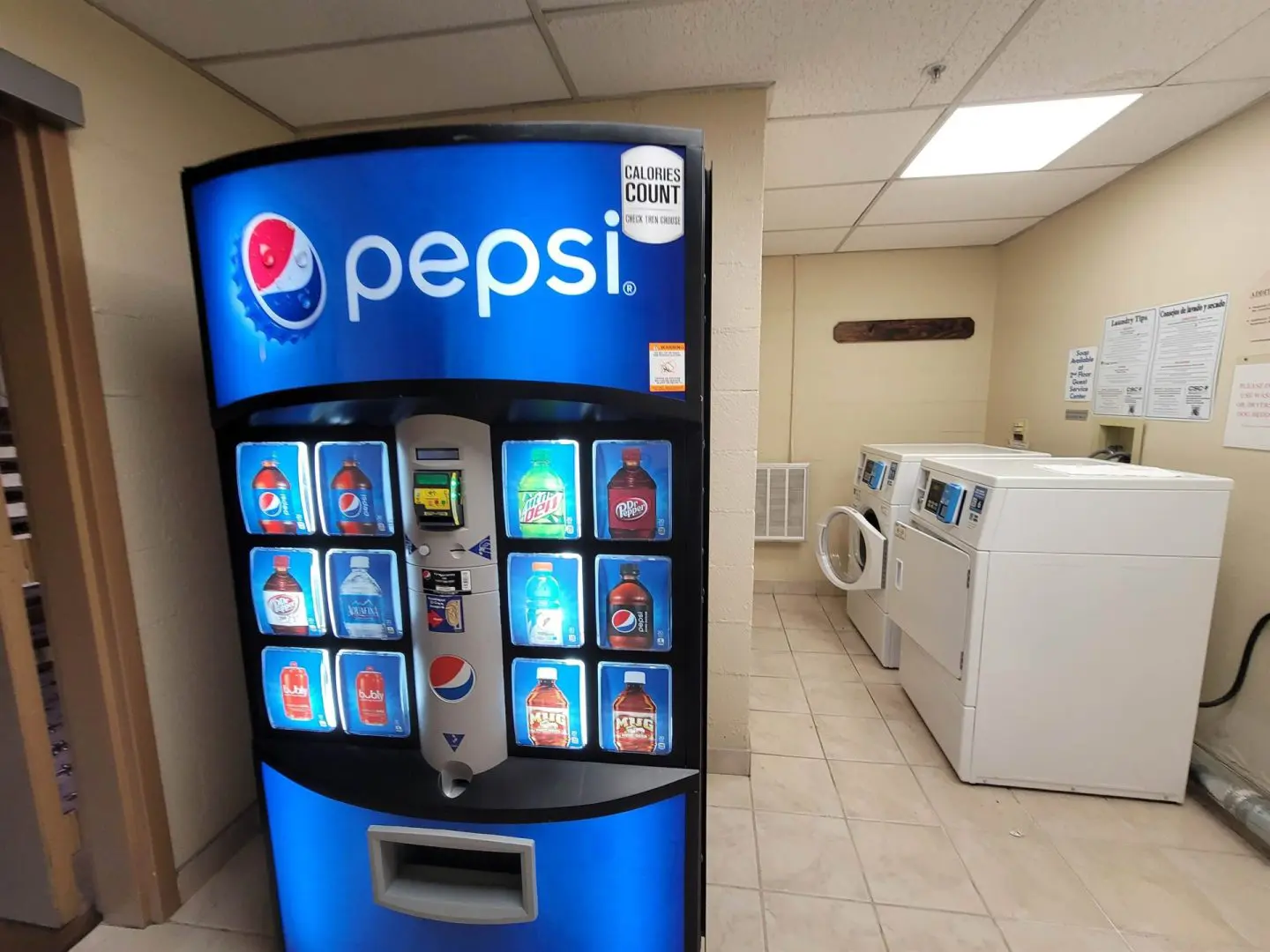 Pepsi vending machine in a laundry room.