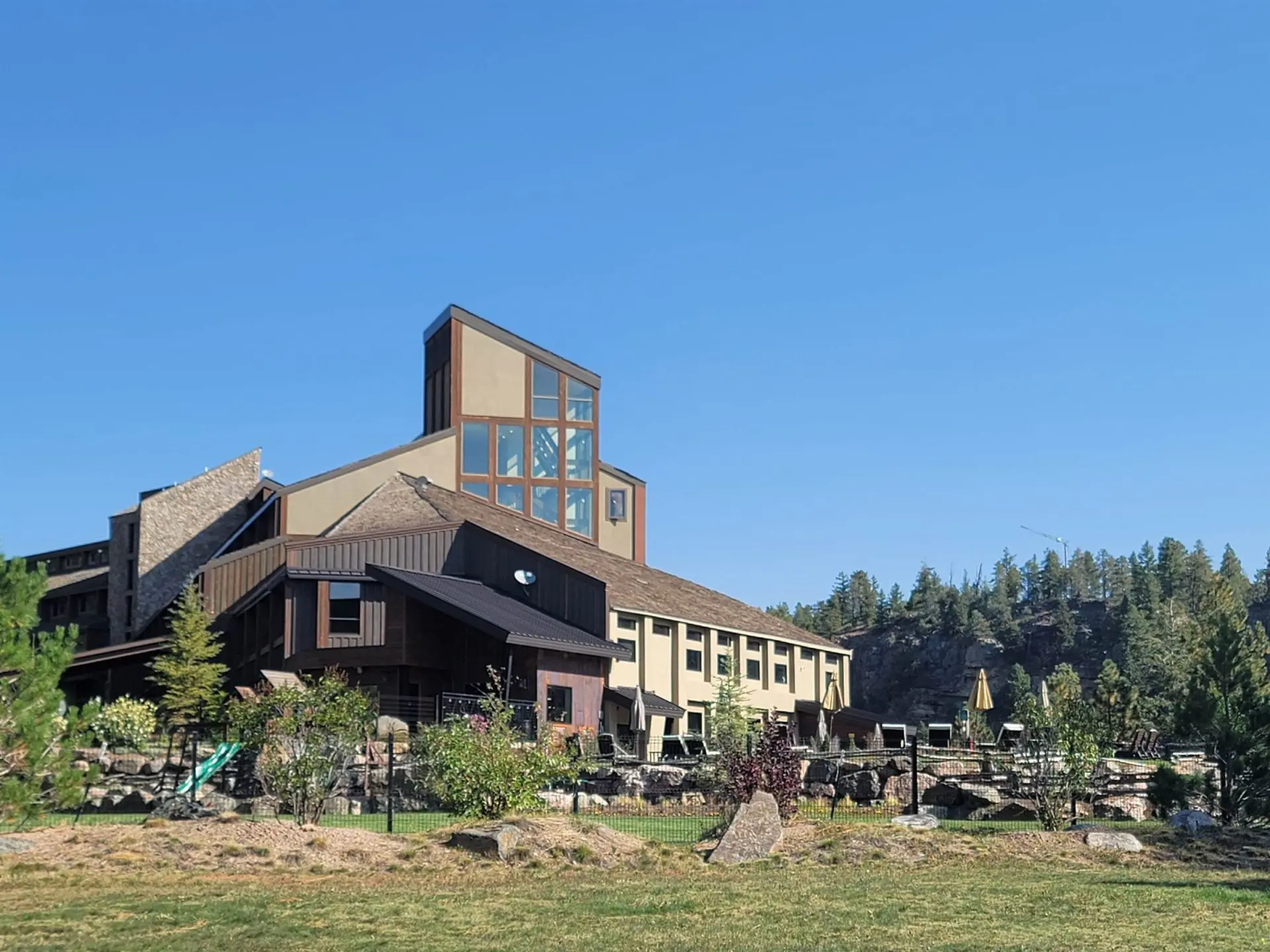 A large building in the middle of a grassy field.