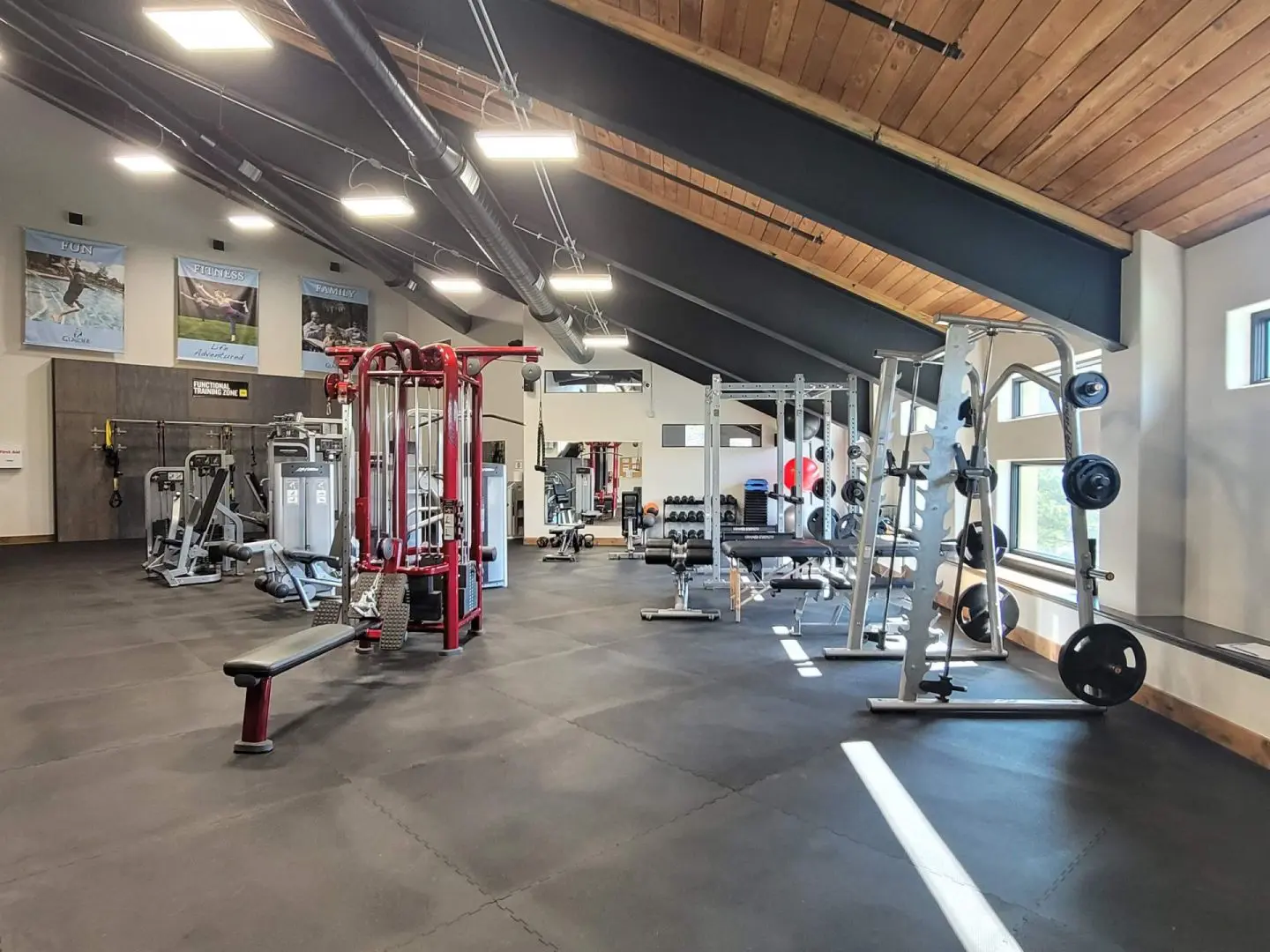 A gym with weights and machines in a large room.