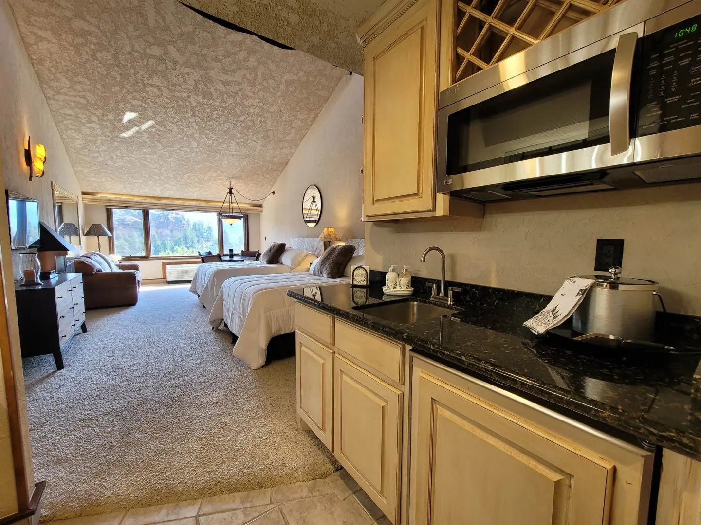 A kitchen with a microwave and a refrigerator.