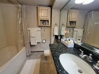 A bathroom with granite counter tops and a sink.