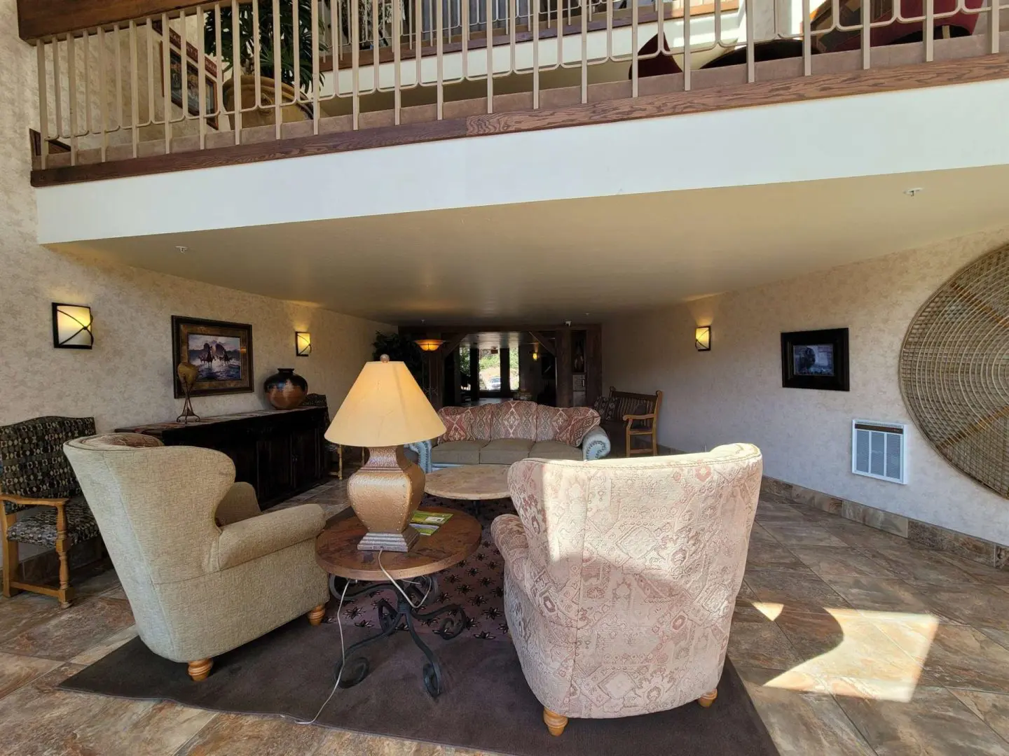 A living room with couches and a balcony.