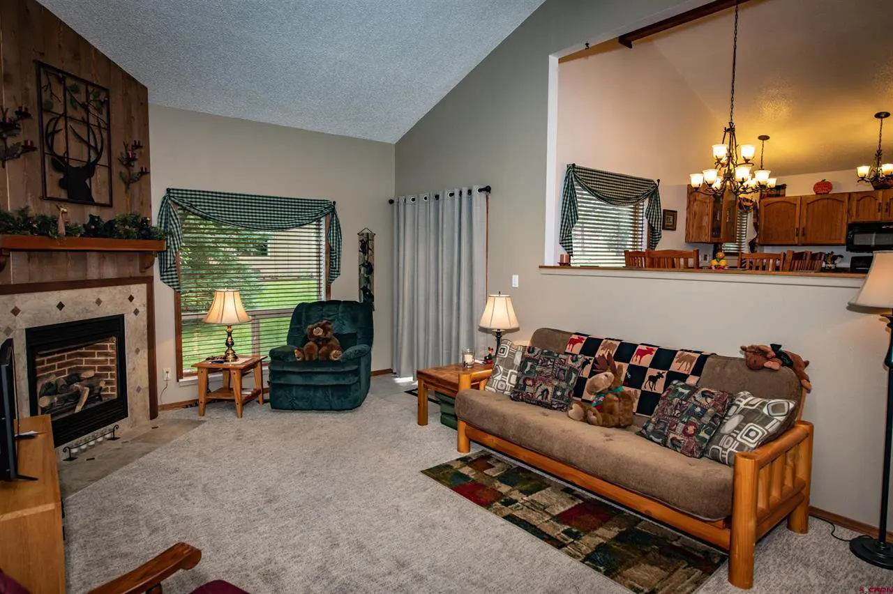 A living room with a fireplace and teddy bears.