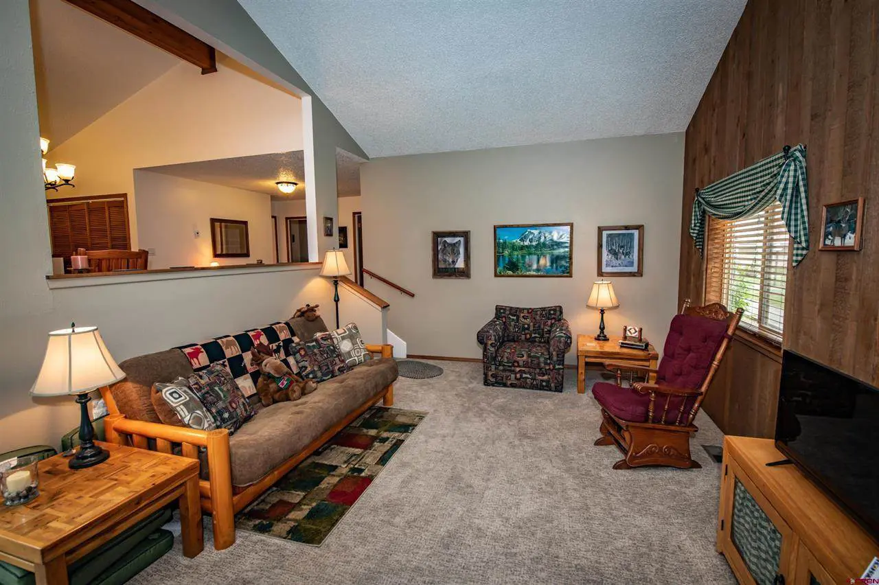 A living room with a couch and a tv.