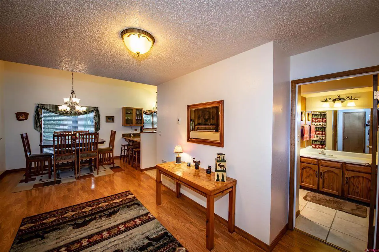 A room with hardwood floors and a dining table.