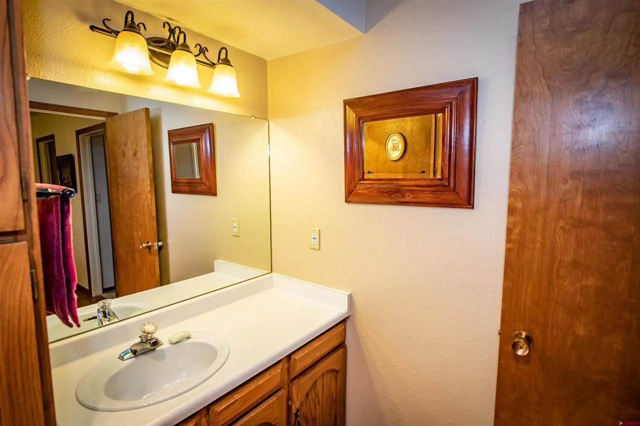 A bathroom with a sink and mirror.