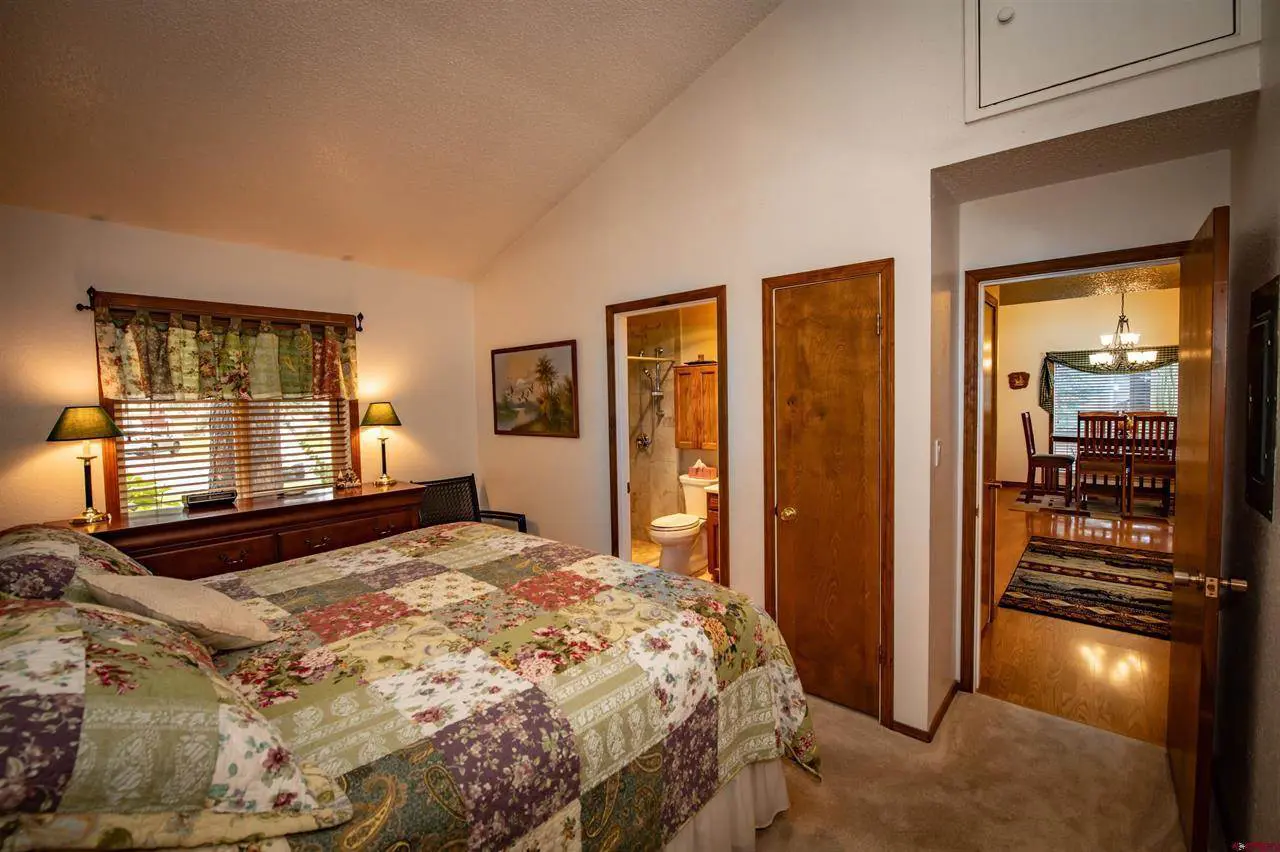 A bedroom with a bed and a dresser.