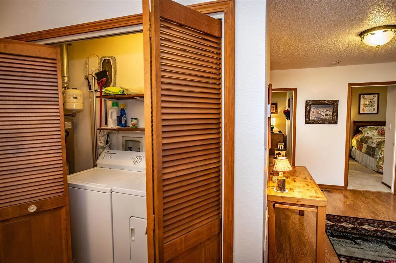 A door leading into a room with a washer and dryer.