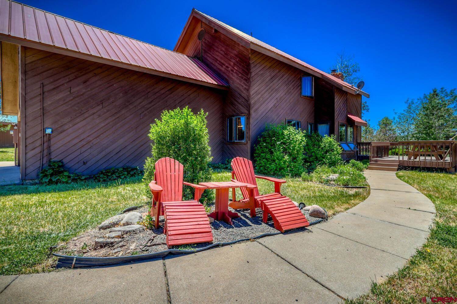 Two chair set placed outside a house