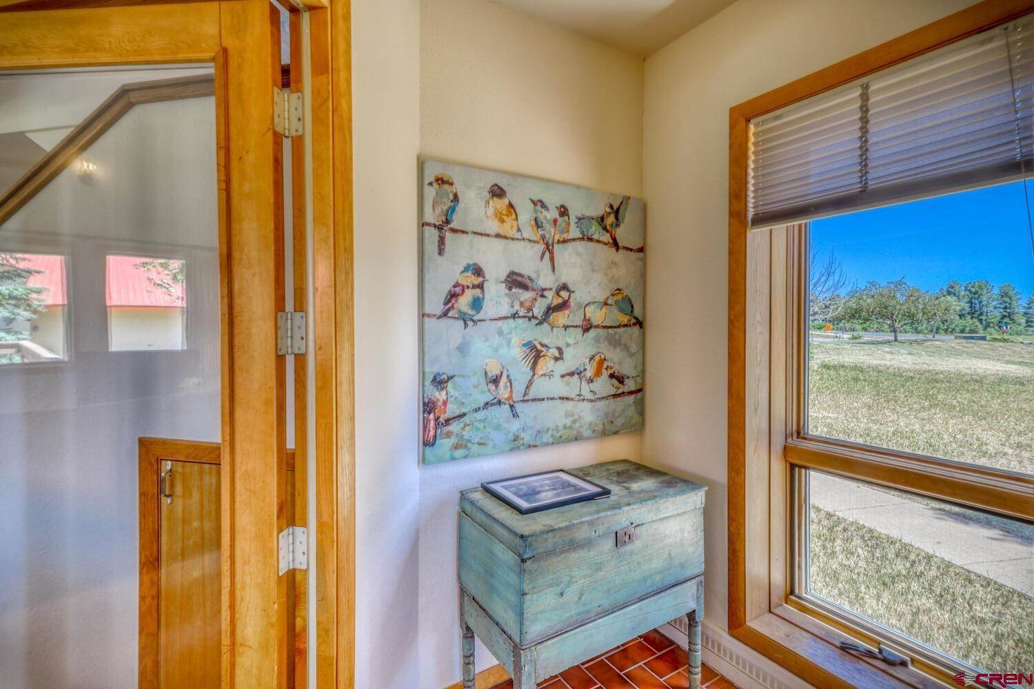 Painting of birds inside a house near window