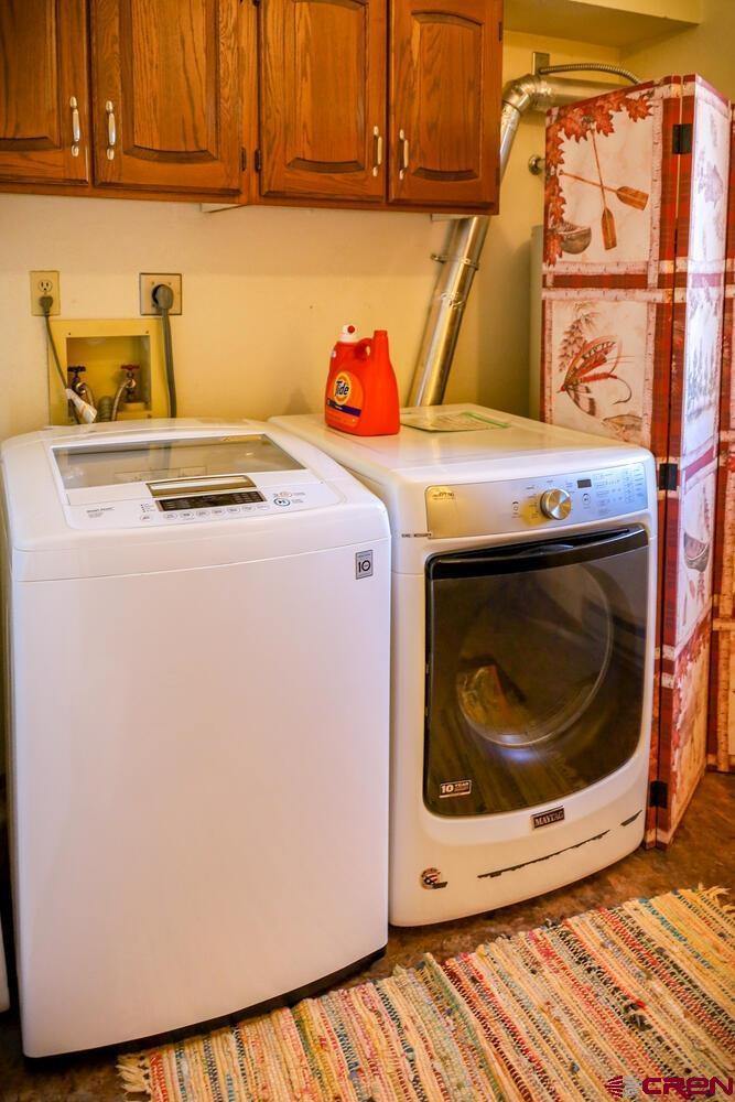 Two white color washing machines inside a room