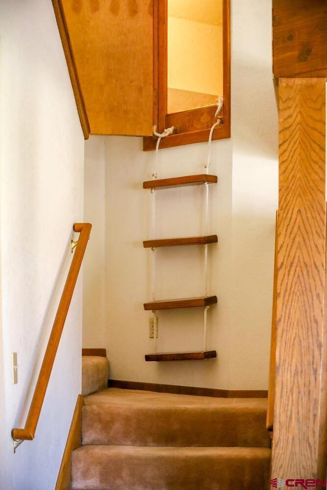 Stairs going upward inside a house in white color