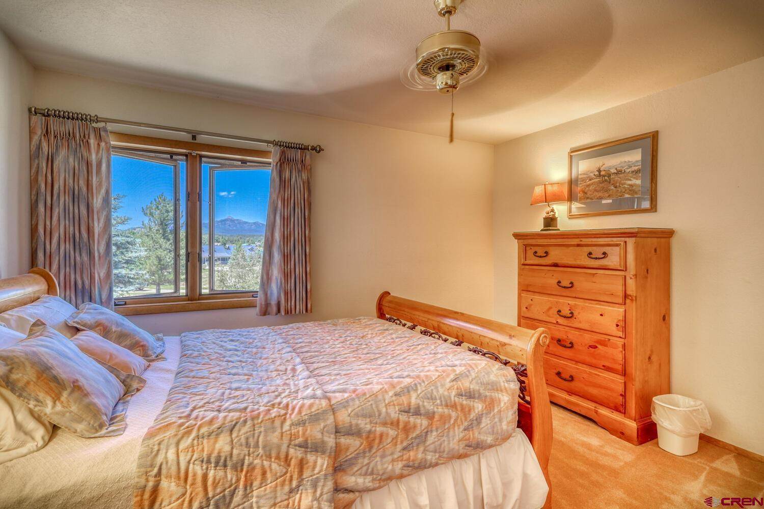 Beautiful bed of a house with a running fan