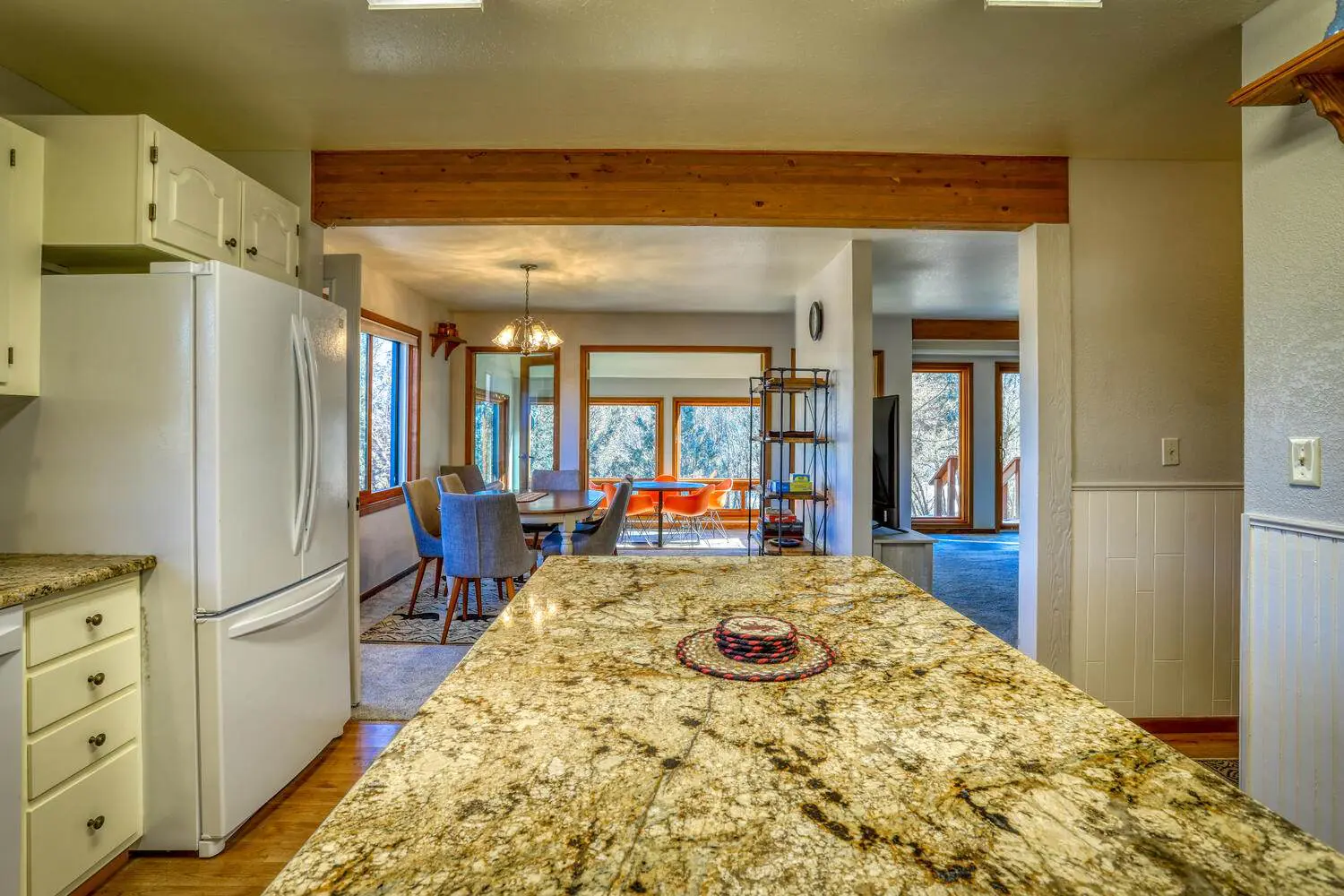 A beautiful table inside the kitchen along with refrigerator