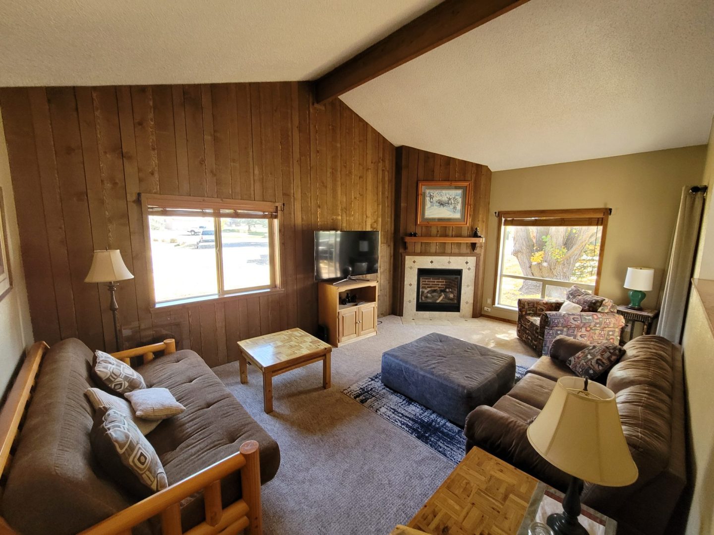 A living room with couches and a fireplace.