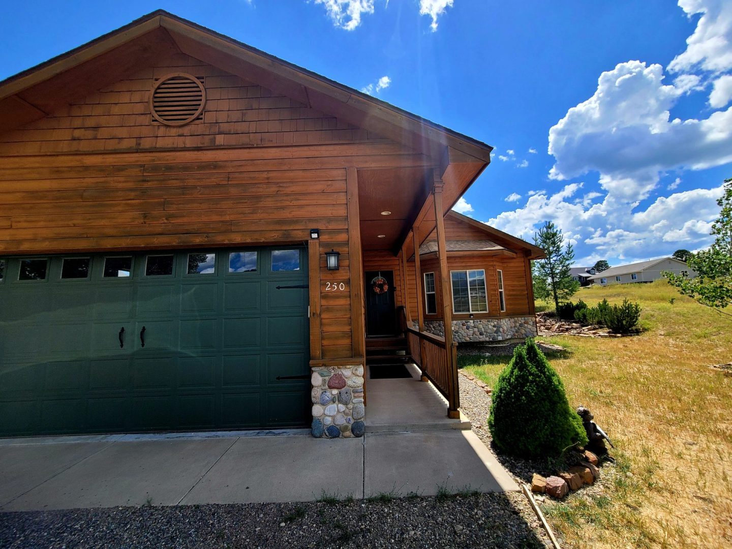 A home with a garage and grass in front of it.