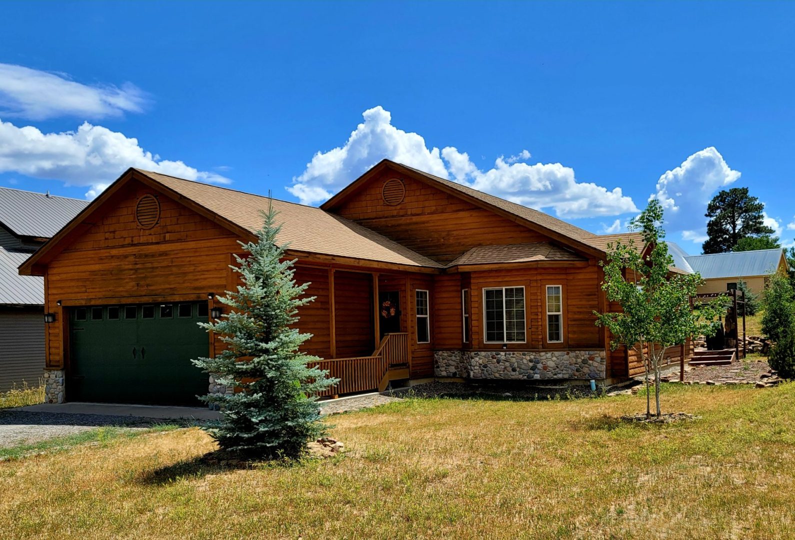 A brown house in a grassy area.