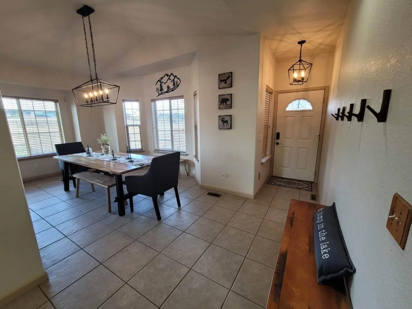 A view of a dining room with a table and chairs.