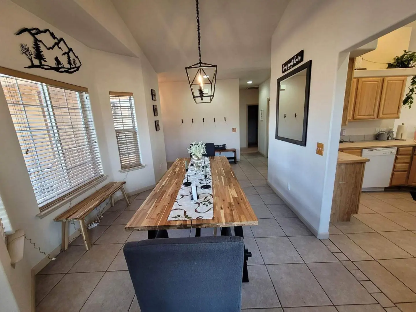 A kitchen with a dining table and chairs.