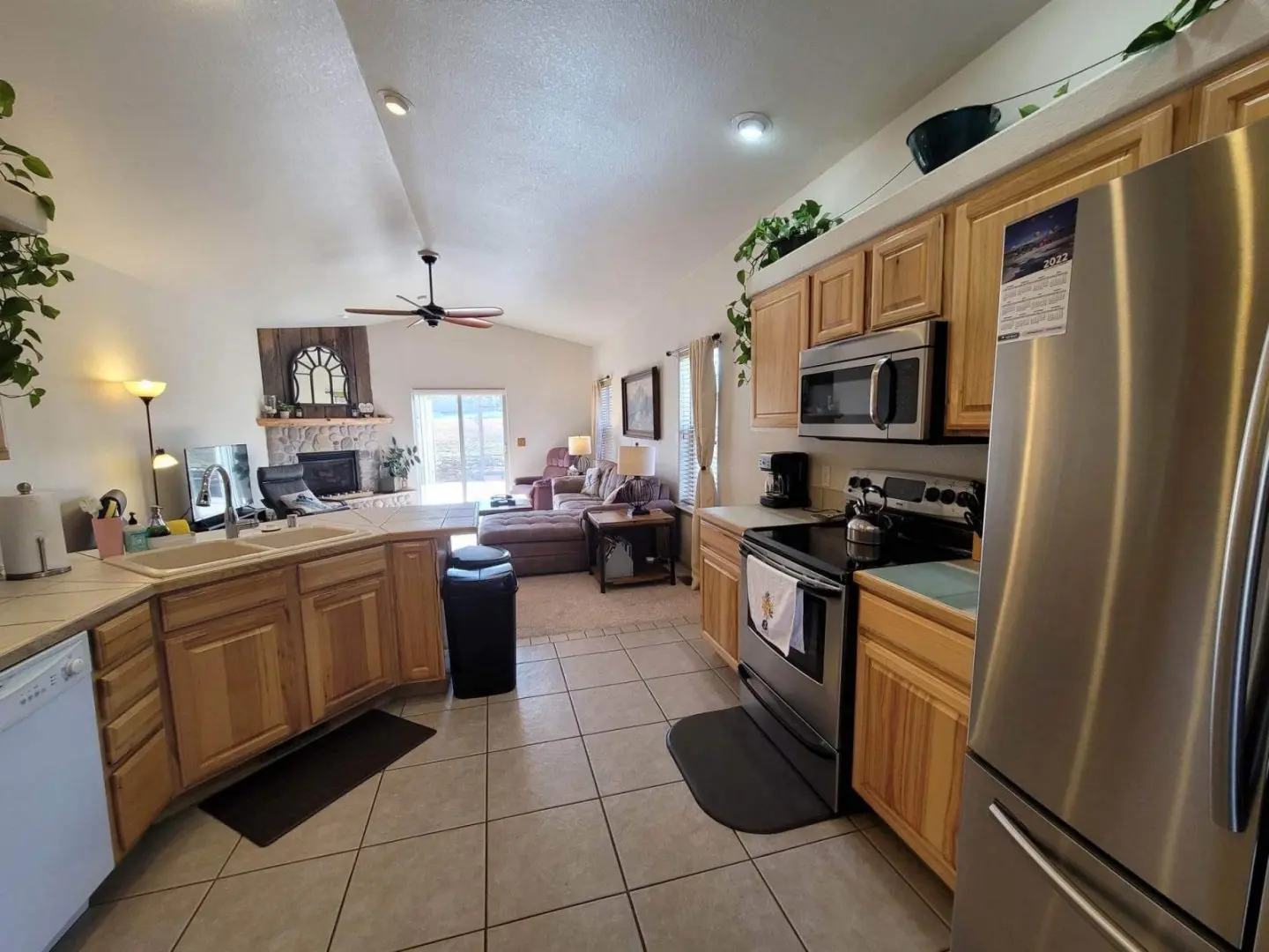 A kitchen with stainless steel appliances and a refrigerator.