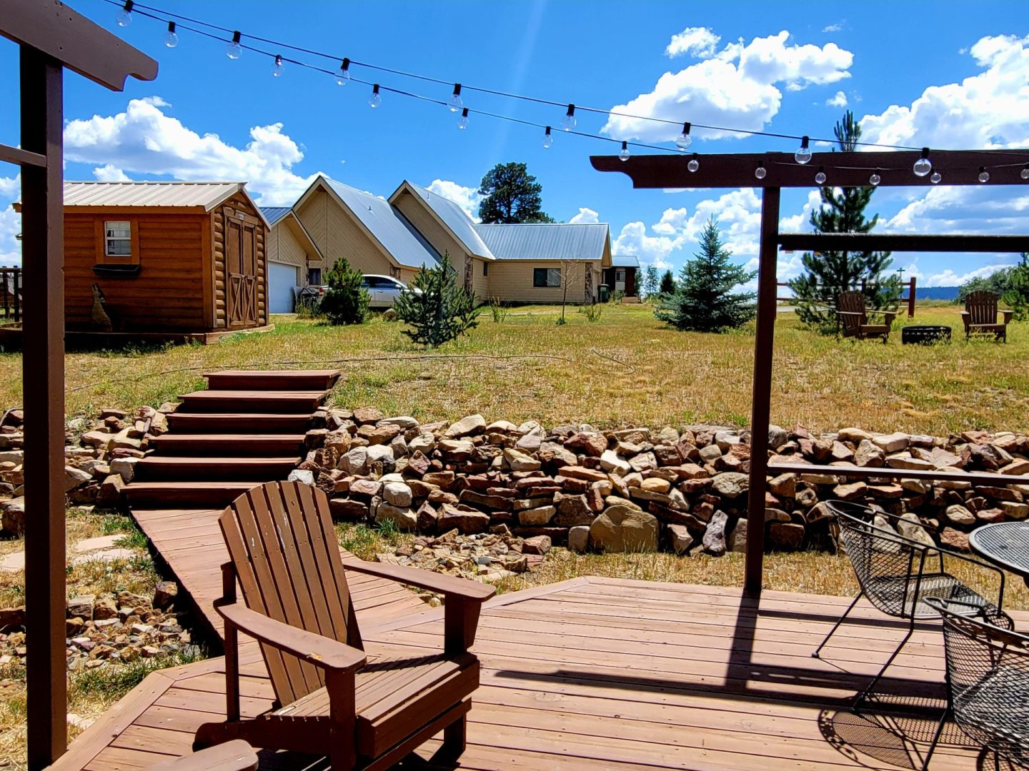 A wooden deck with a wooden table and chairs.