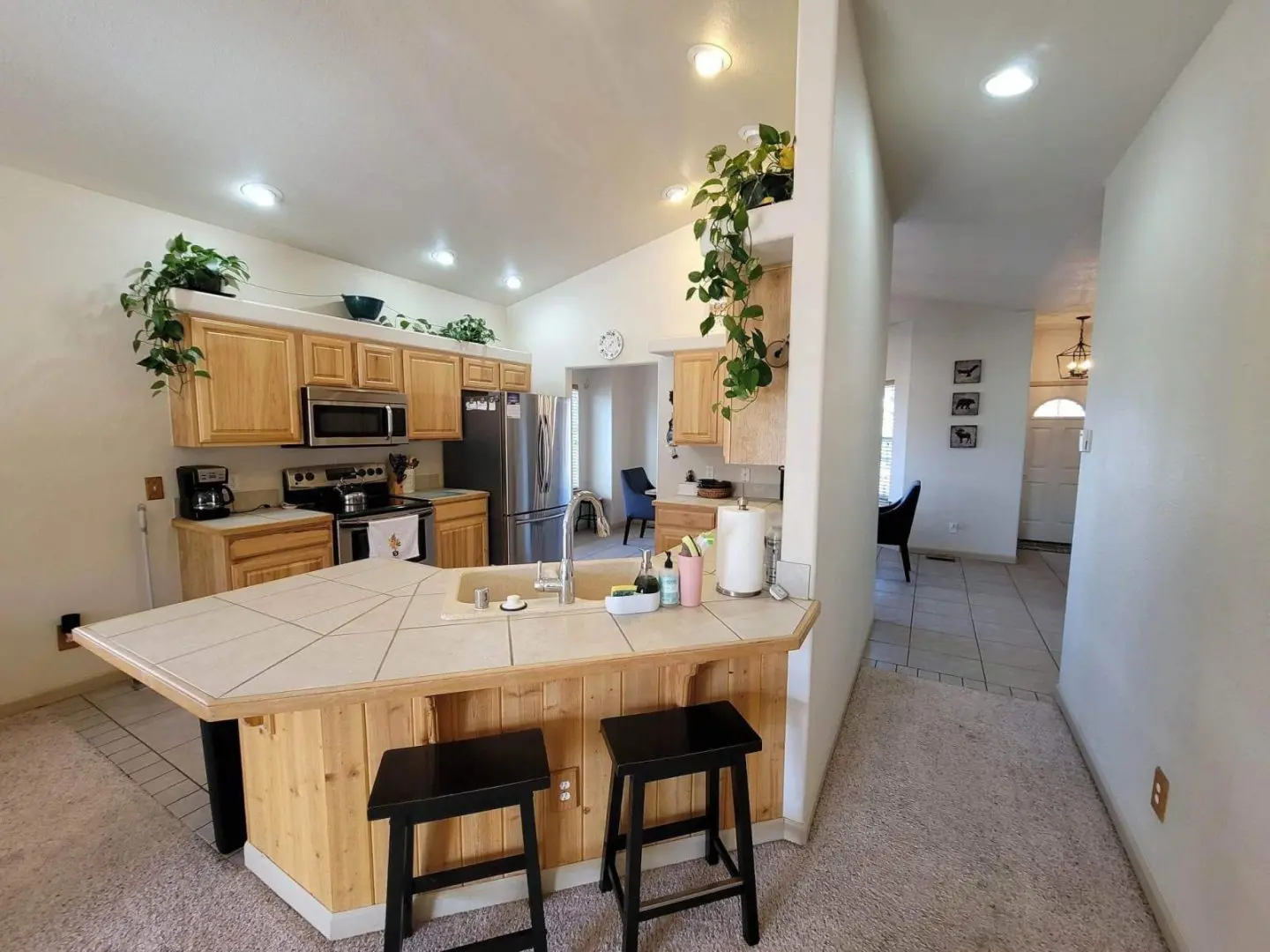 A kitchen with stools and a counter top.