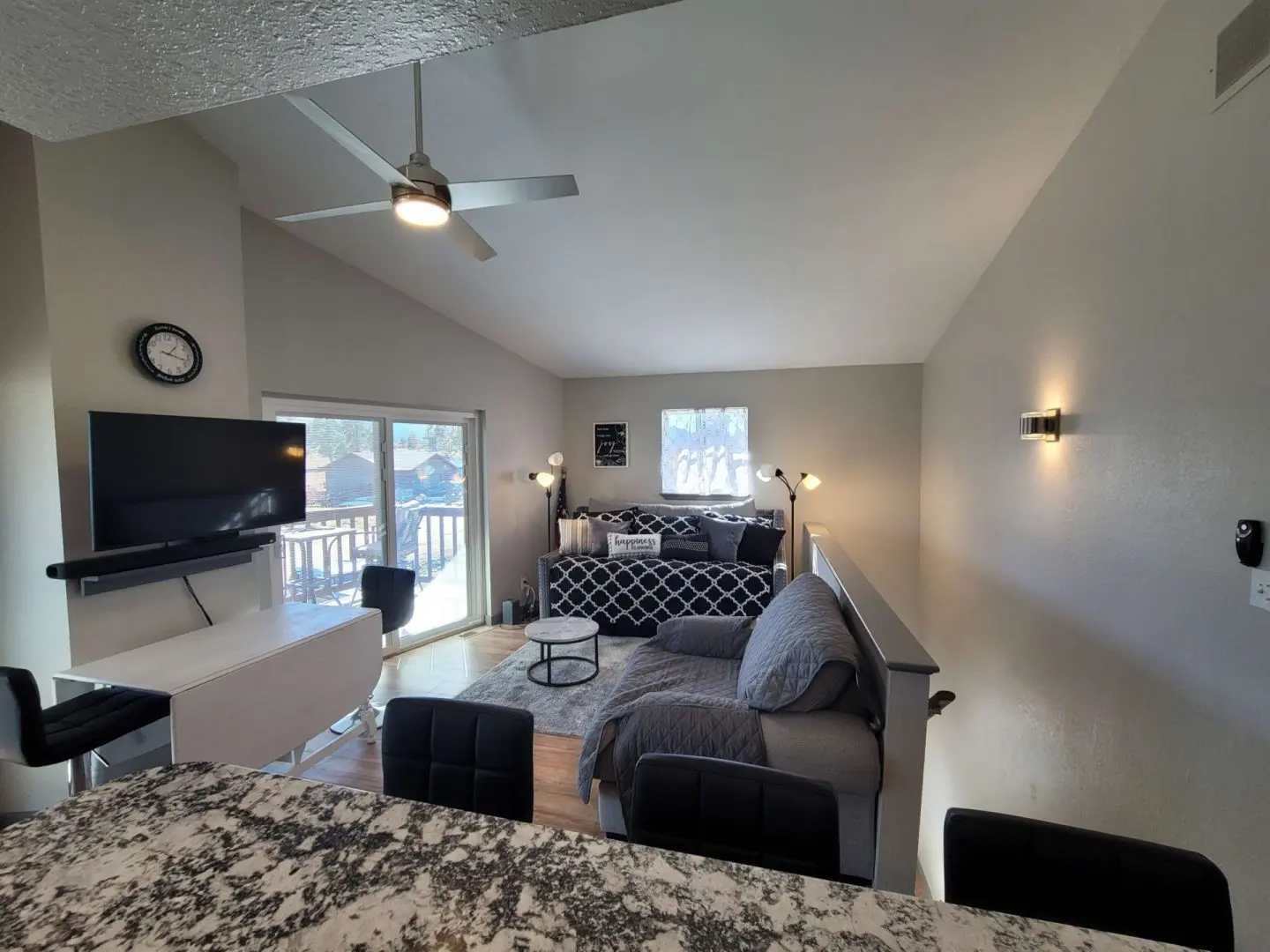 A living room with a couch and a flat screen tv.