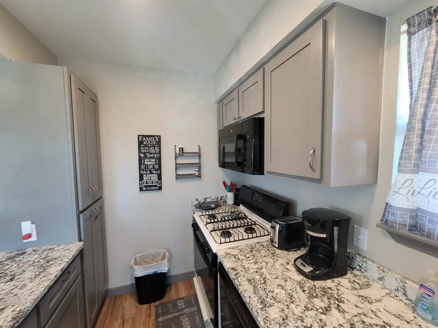 A kitchen with granite counter tops and stainless steel appliances.