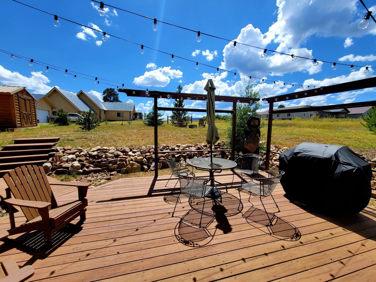 A wooden deck with a table and chairs.