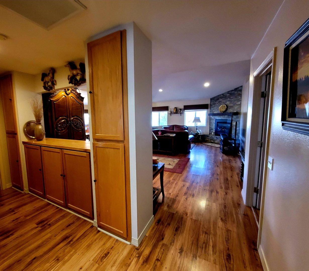 A living room with hardwood floors and a fireplace.