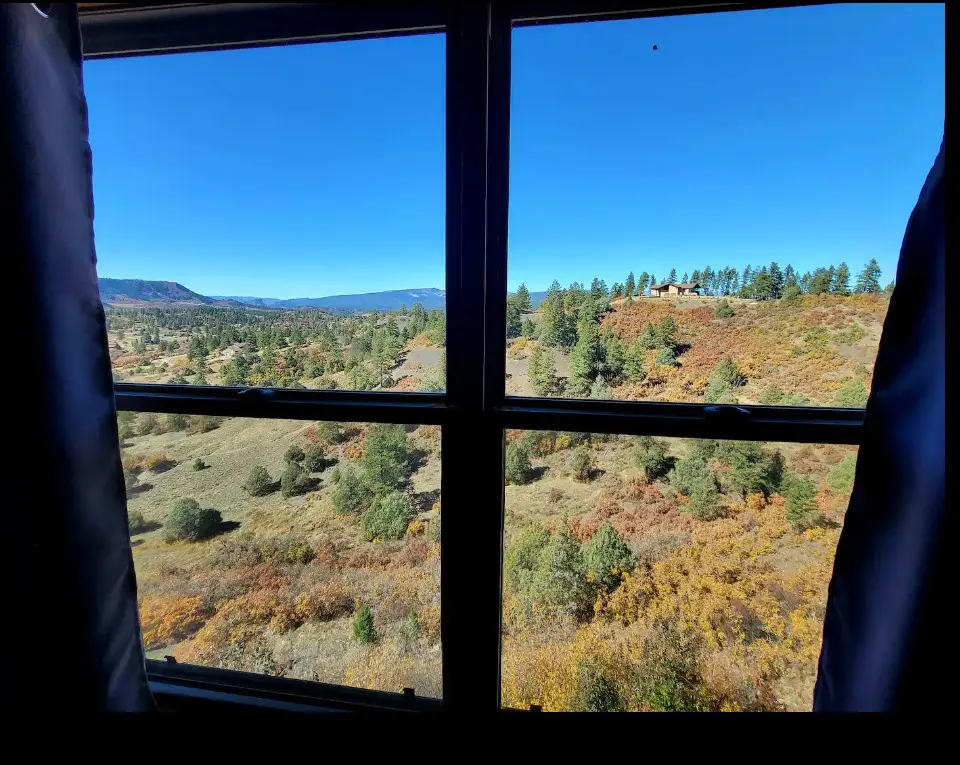 A view from the window of a cabin in the mountains.