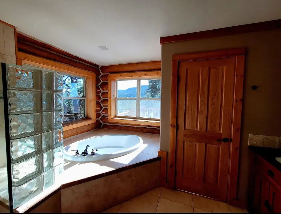 A bathroom with a tub and a view.