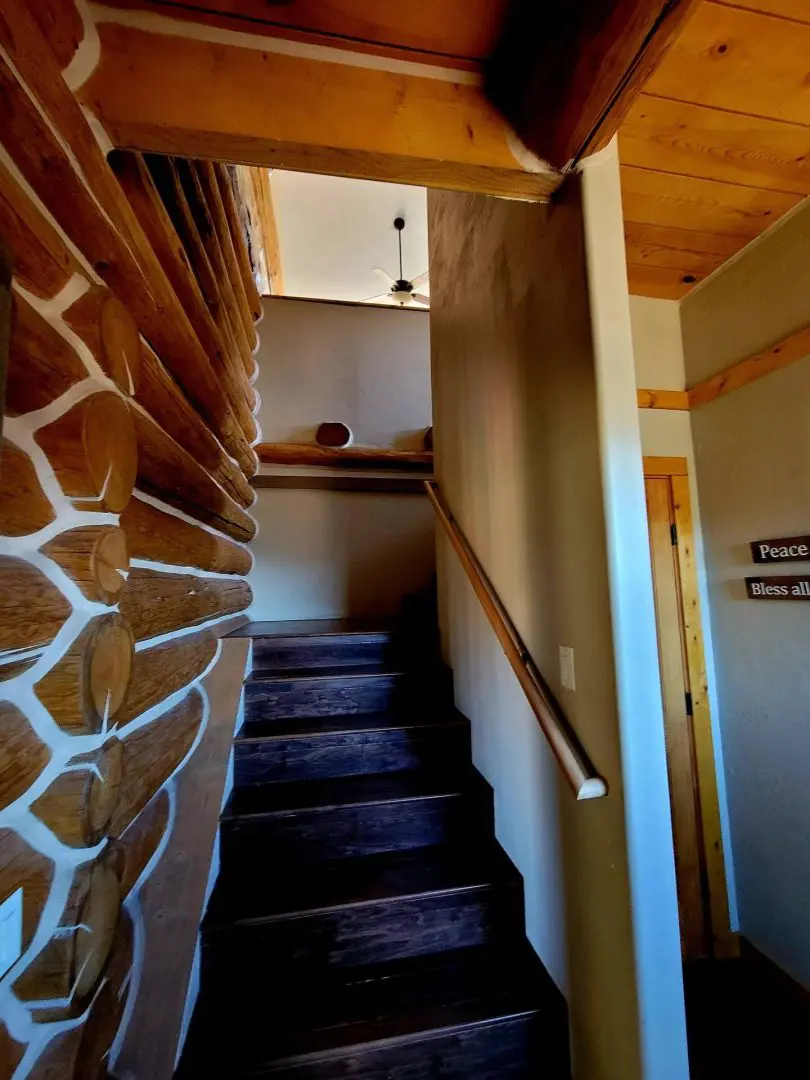 A stairway leading up to a log cabin.