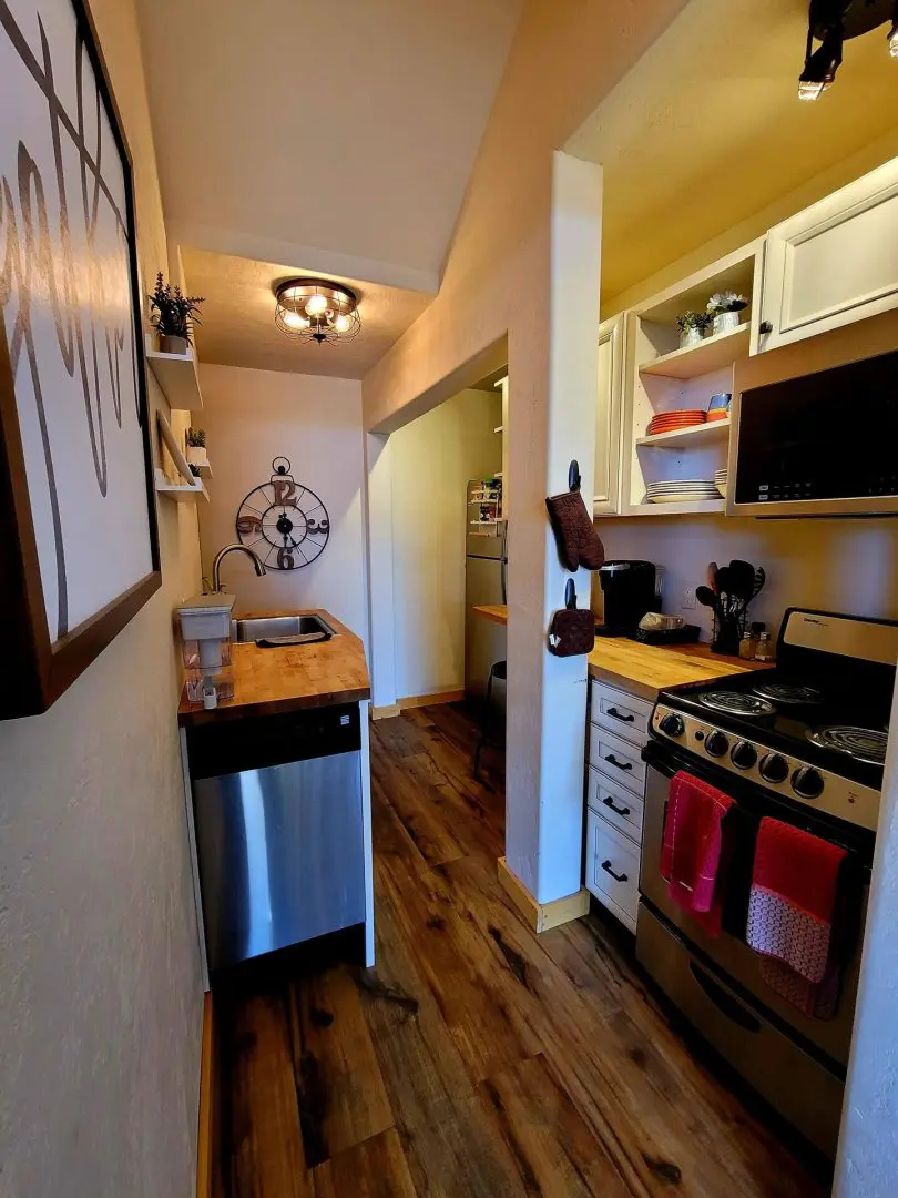 A kitchen with wood floors and a stove.