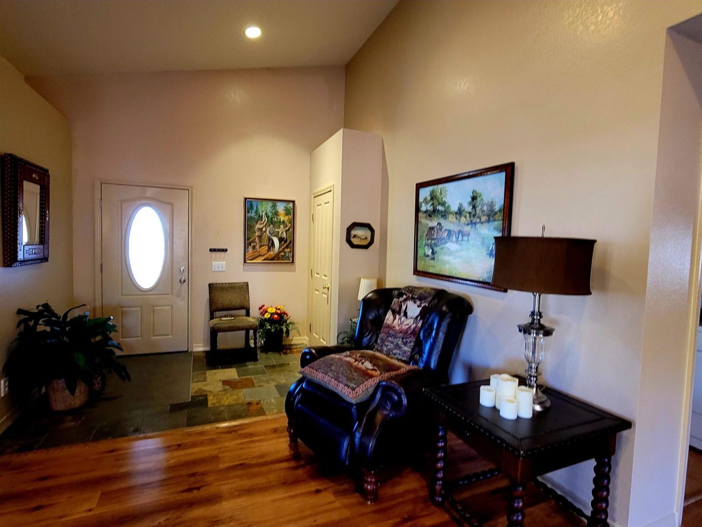 A living room with hardwood floors and a chair.