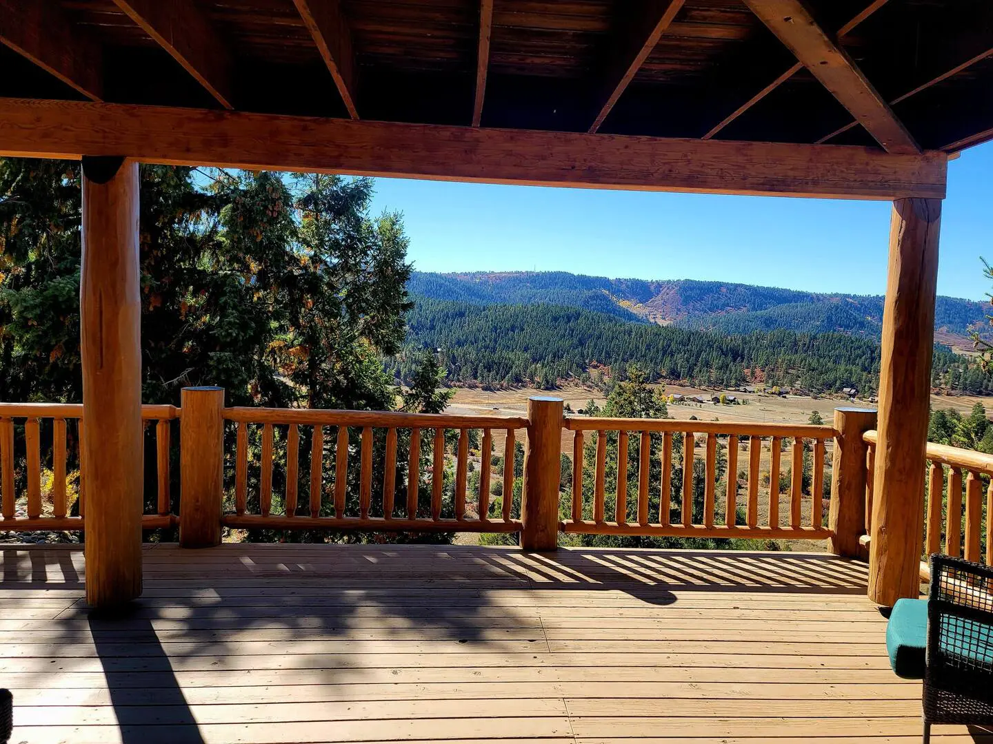 A wooden deck with a view of the mountains.