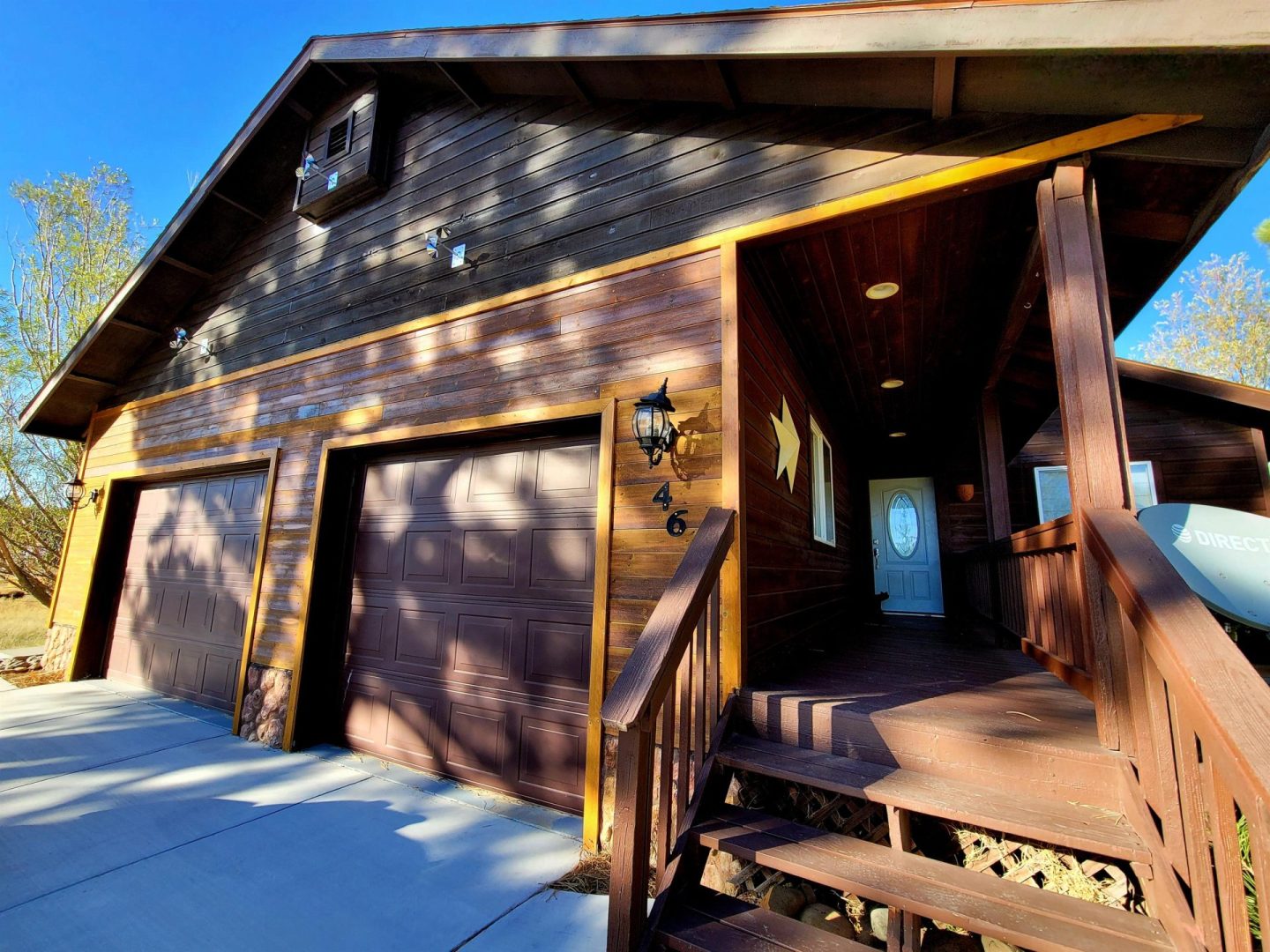 A house with two garages and a front porch.