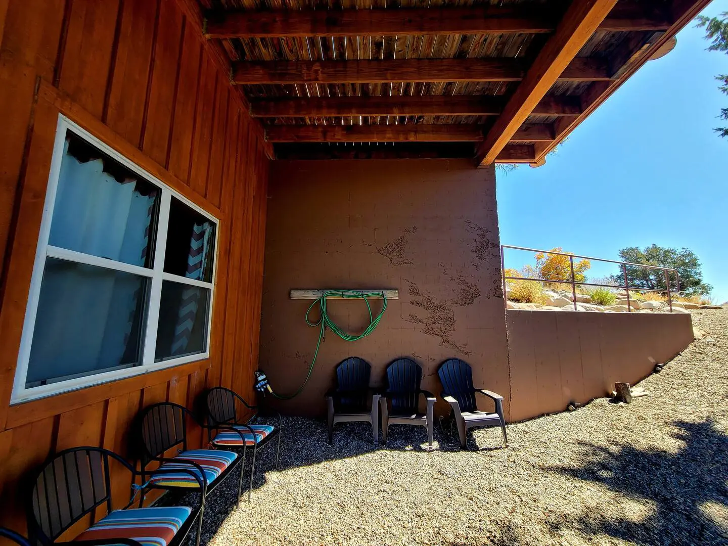 A patio with chairs and a window.