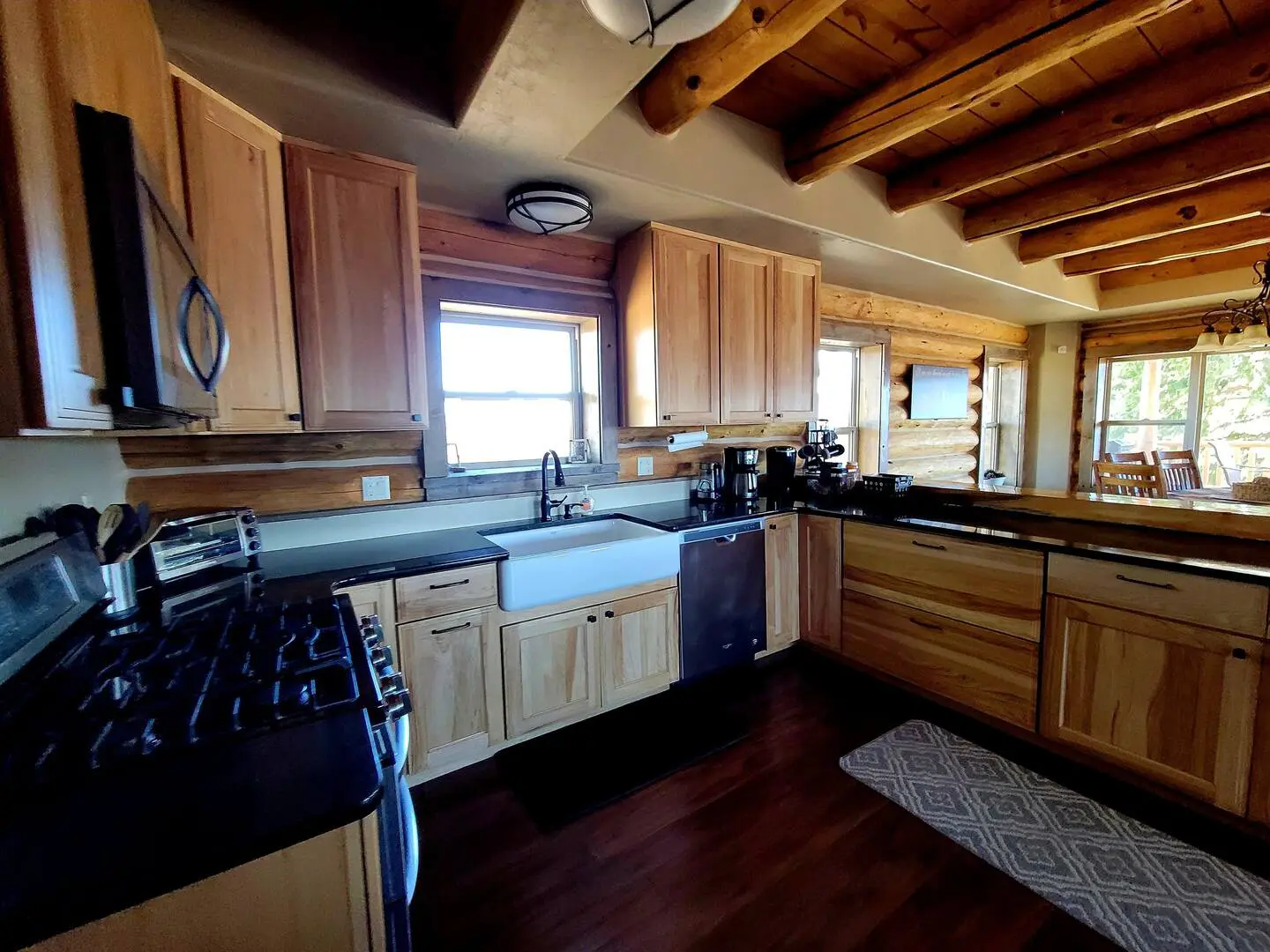 A kitchen with wood cabinets and a stove.