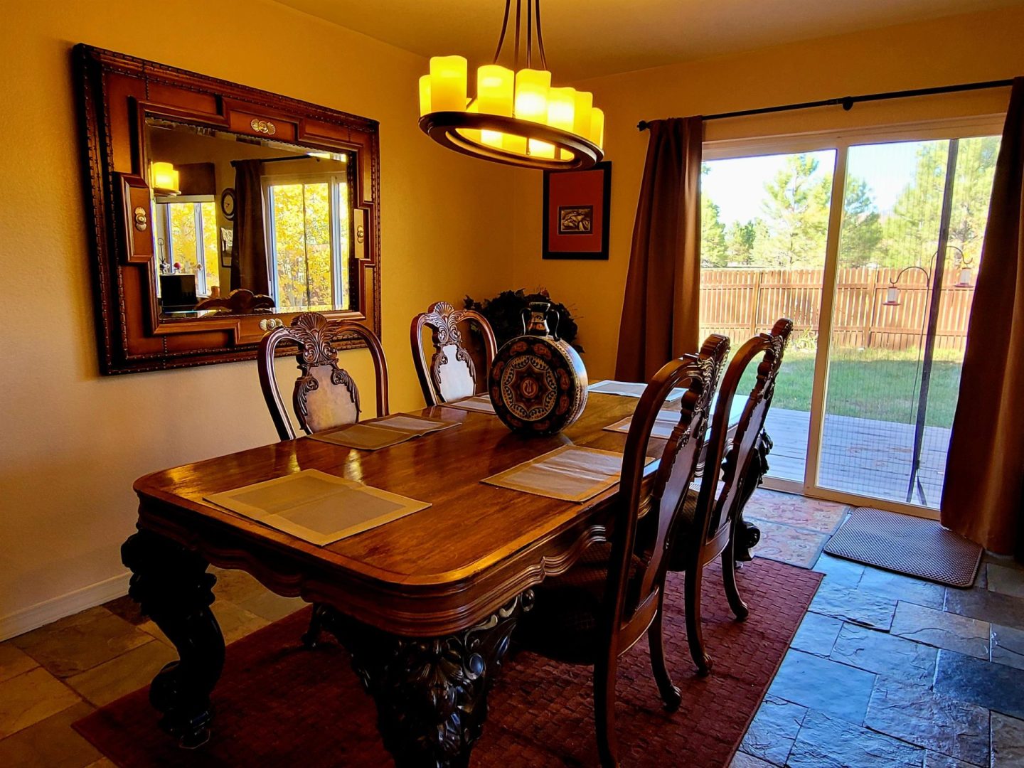 A dining room with a table and chairs.