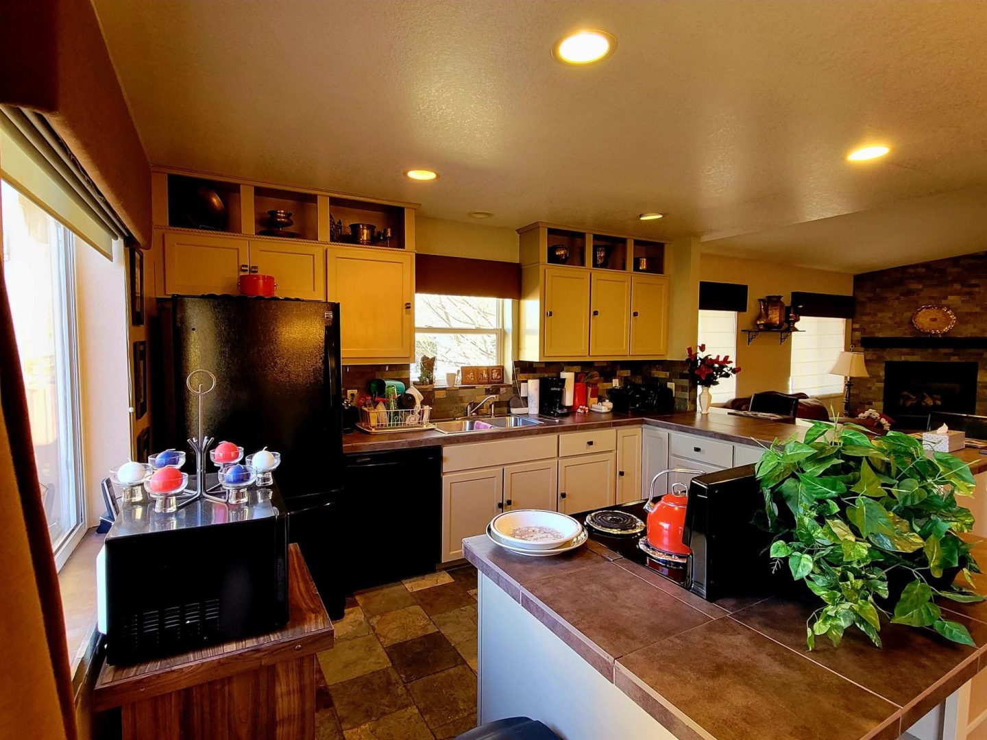 A kitchen with a stove and refrigerator.