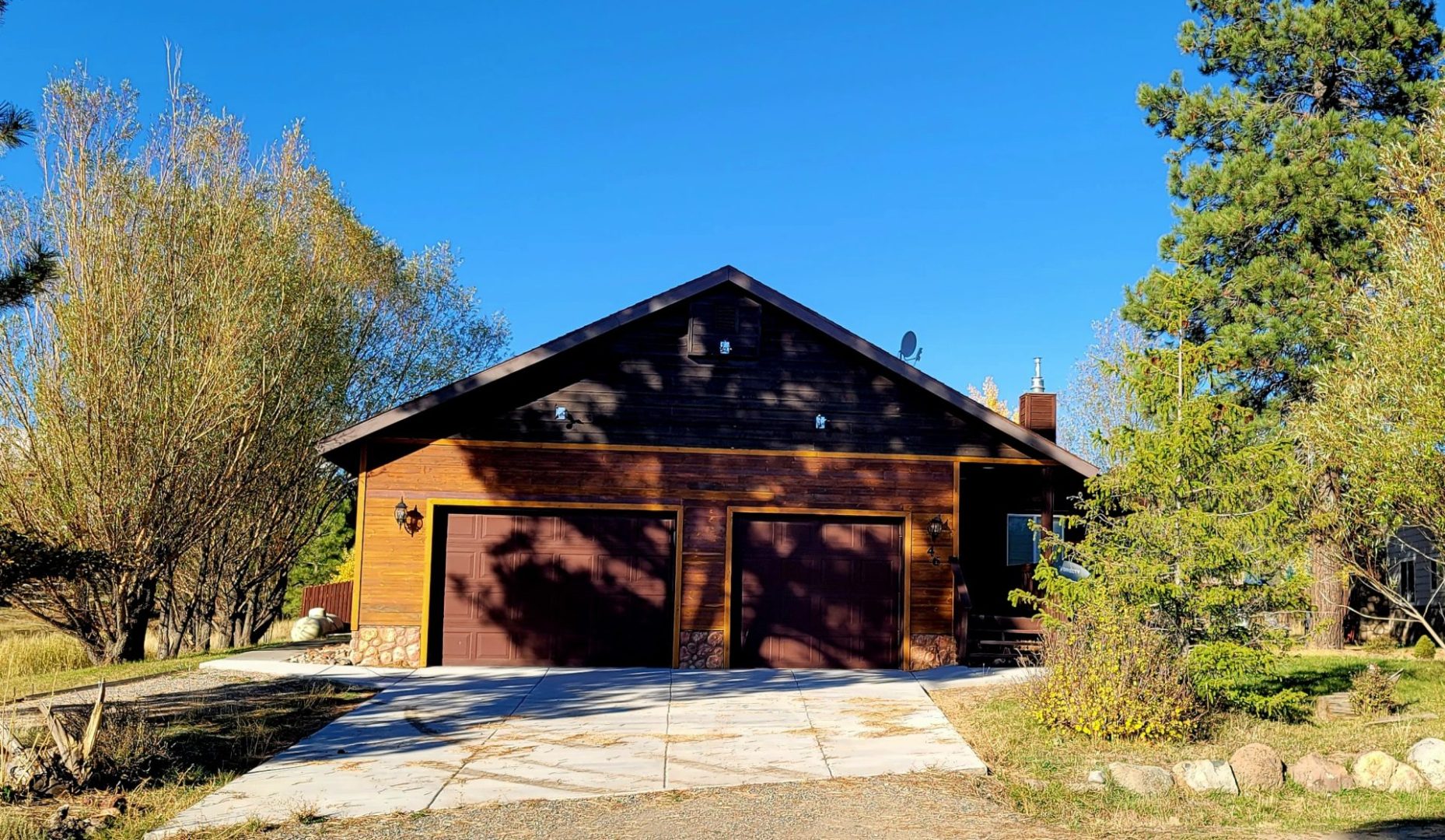 A house with two garages and a driveway.