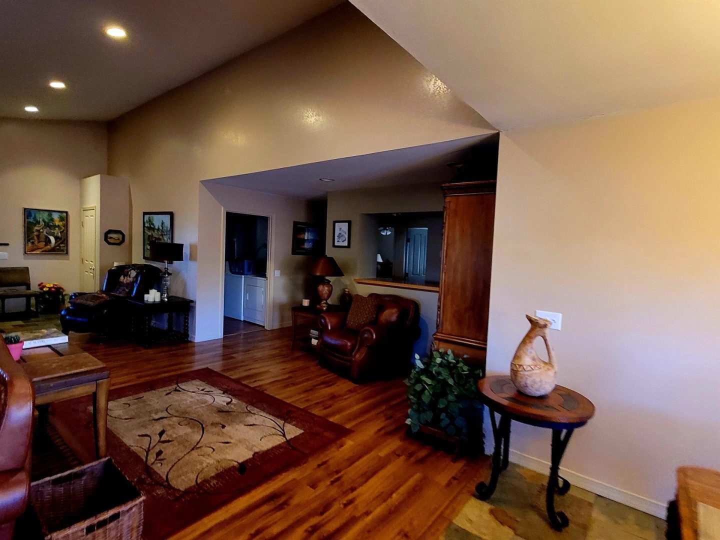 A living room with hardwood floors and a fireplace.