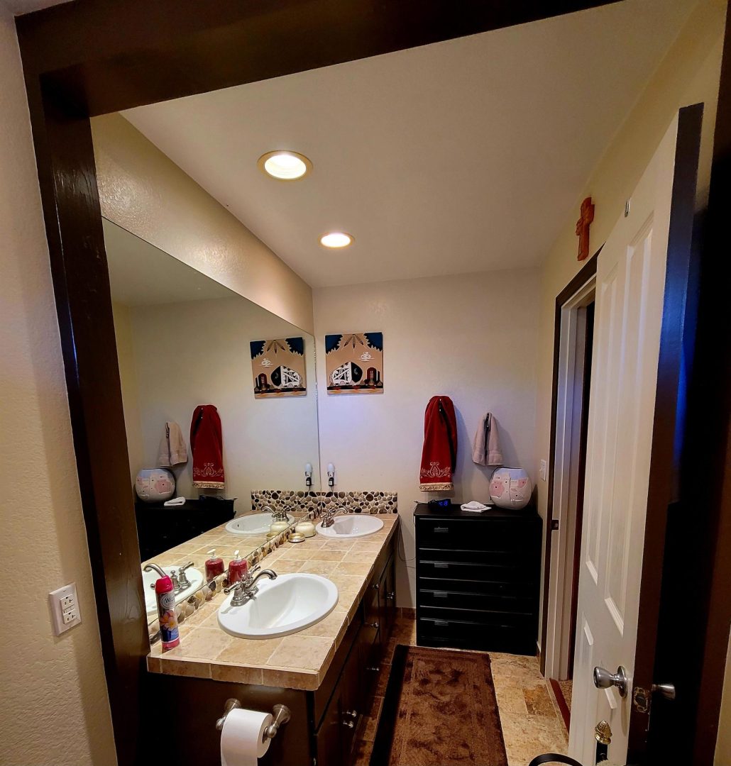 A bathroom with two sinks and a mirror.