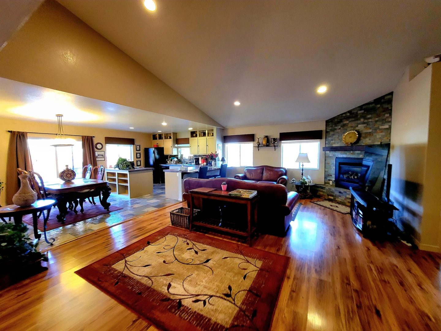 A living room with hardwood floors and a fireplace.